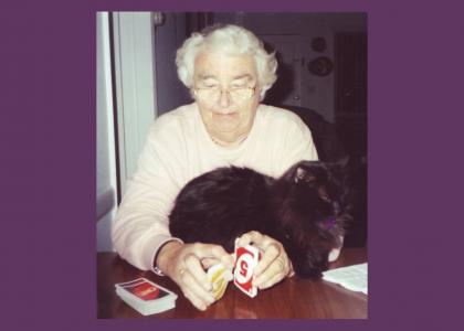 A grandma and a cat playing UNO®